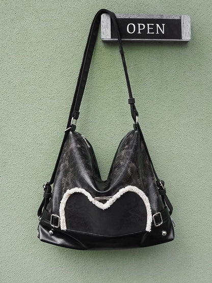 Stylish black tote backpack with heart embellishment - can be worn on one shoulder or as a backpack - Image 2