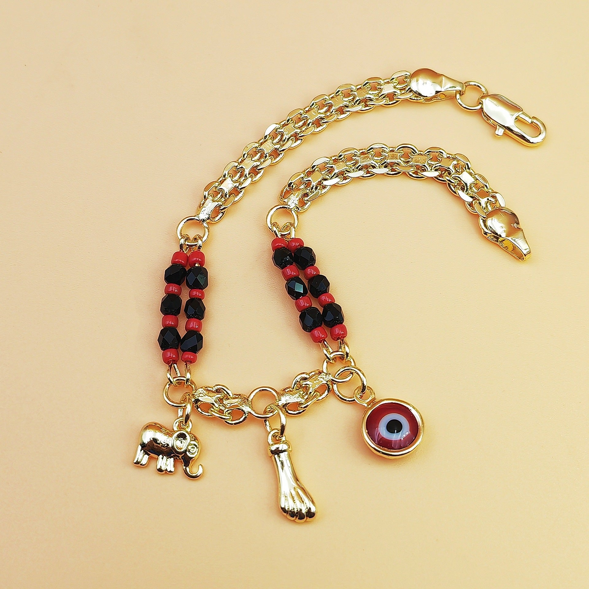 Gold-Tone Chain Bracelet with Red and Black Beads, Elephant Charm, Feather Pendant, and Round Stone Accent – 19 cm Length - Image 2